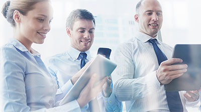 Three Colleagues looking at different mobile devices