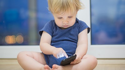 Baby boy holding a smartphone.