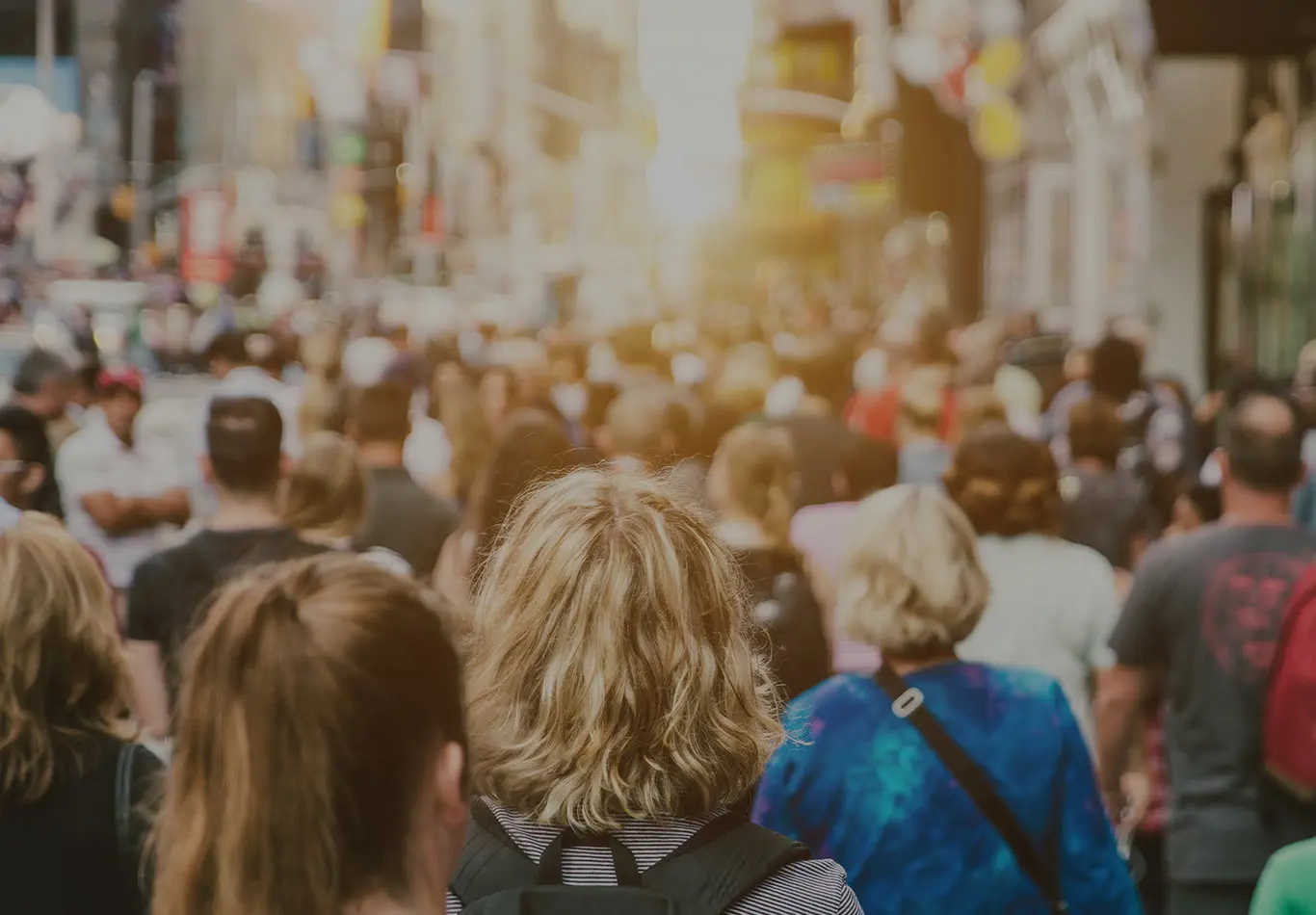A crowd full of many people on the street. 
